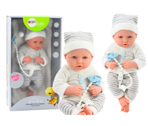 Baby doll in white and gray striped clothes, hat, pacifier, quilt