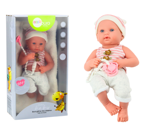 Baby doll in white and pink clothes, hat, pacifier, and blanket